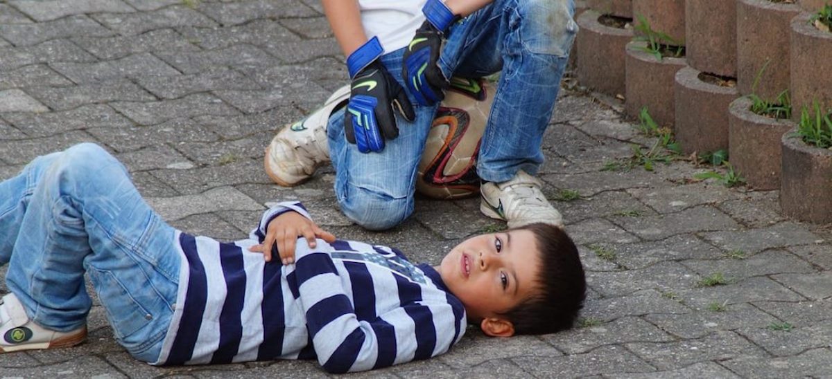Child lying on ground